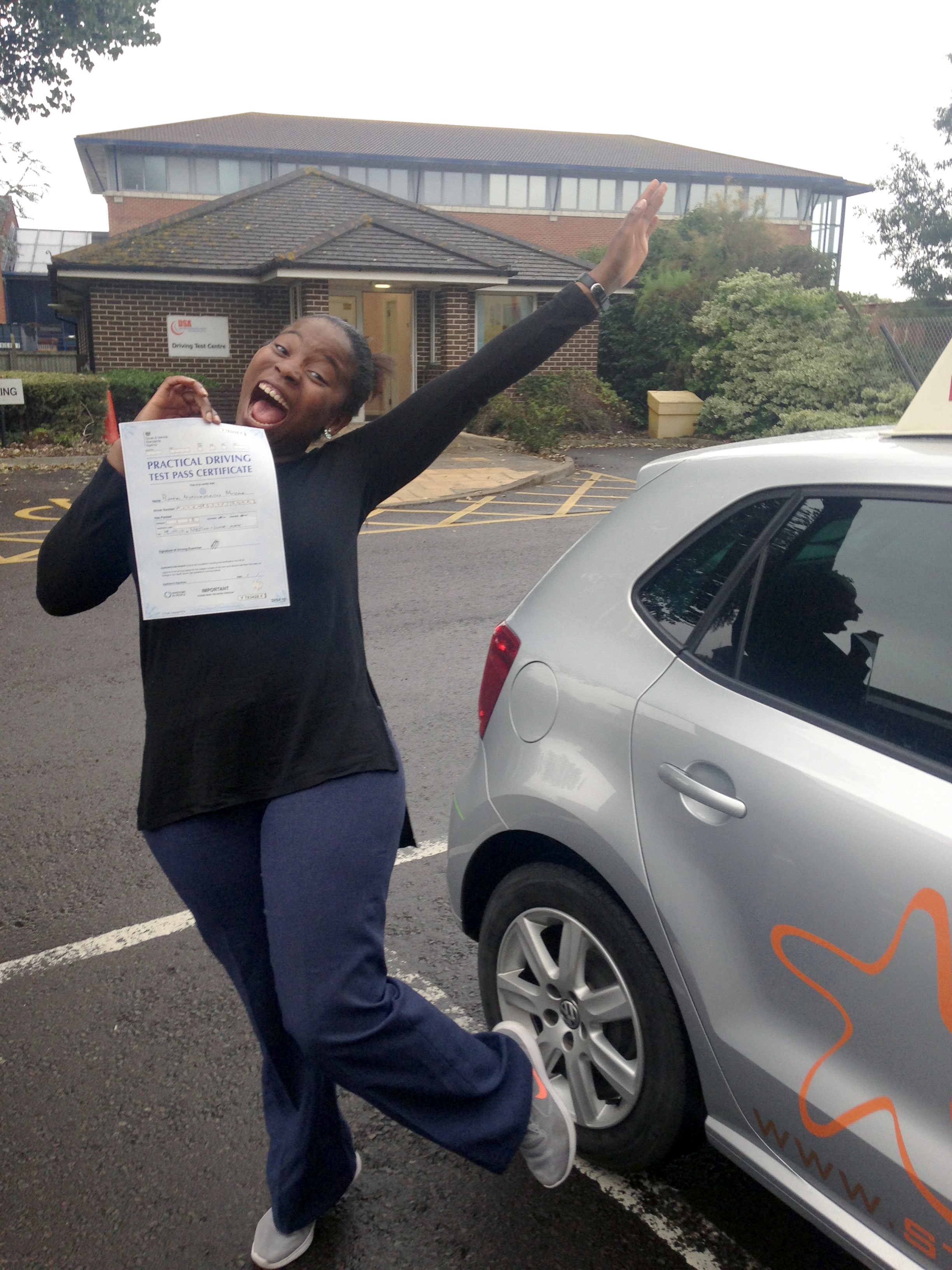 A happy Bongai with her Practical Driving Test Pass Certificate outside Weston-super-Mare Driving Test Centre.