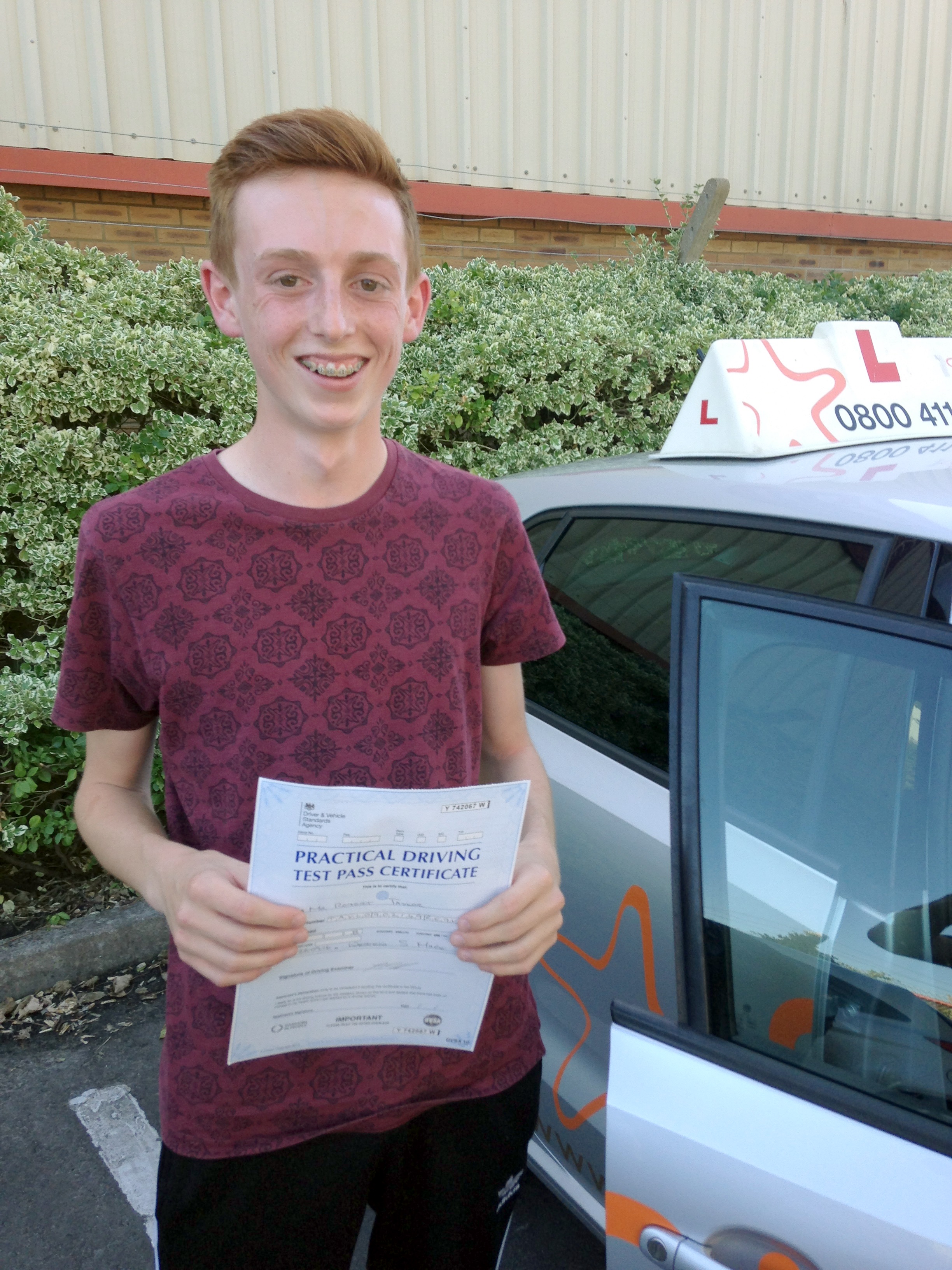 Robert with his Practical Driving Test Pass Certificate outside Weston-Super-Mare Driving Test Centre