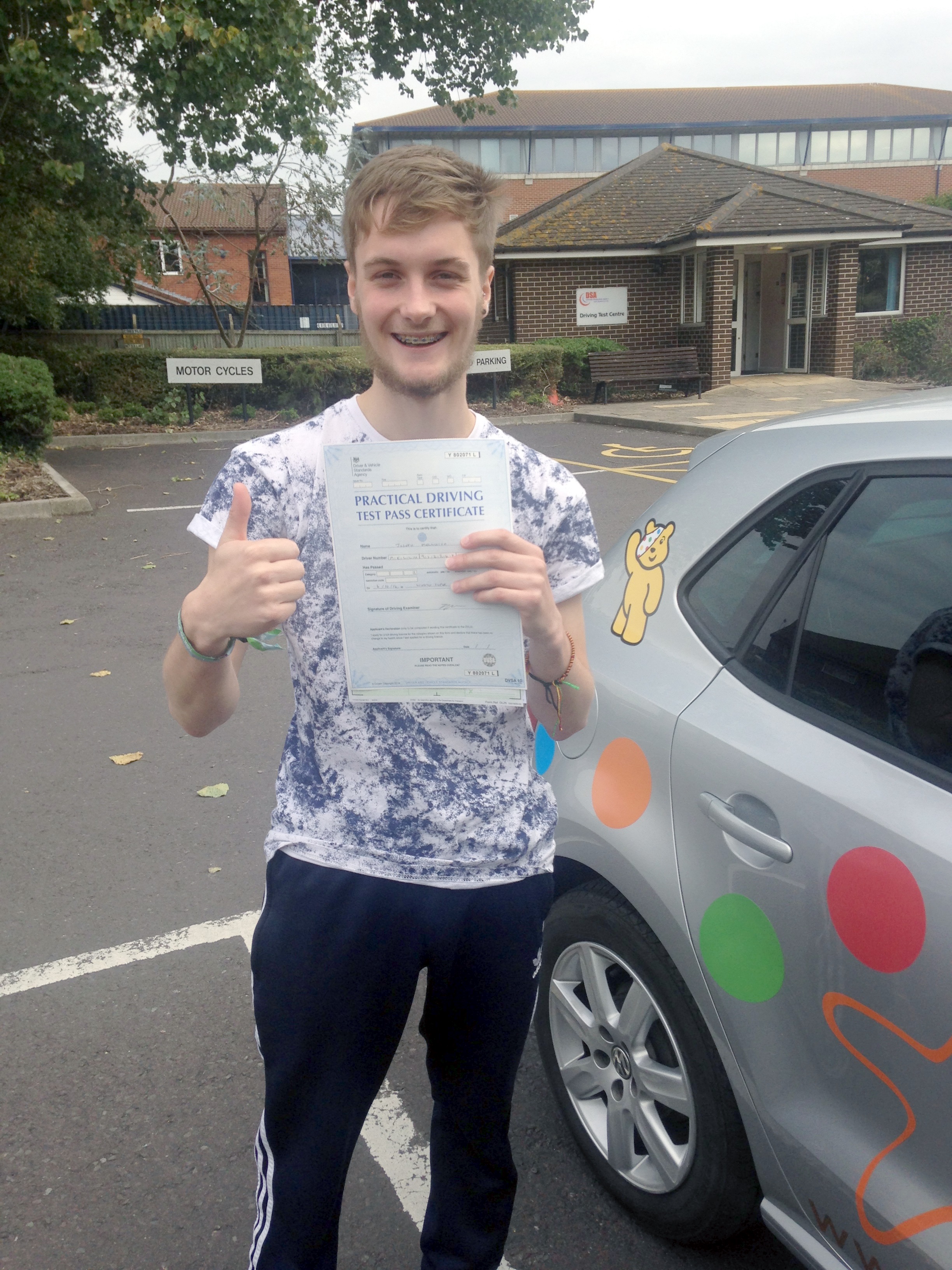 Joe with his Practical Driving Test Pass Certificate outside Weston-Super-Mare Driving Test Centre.
