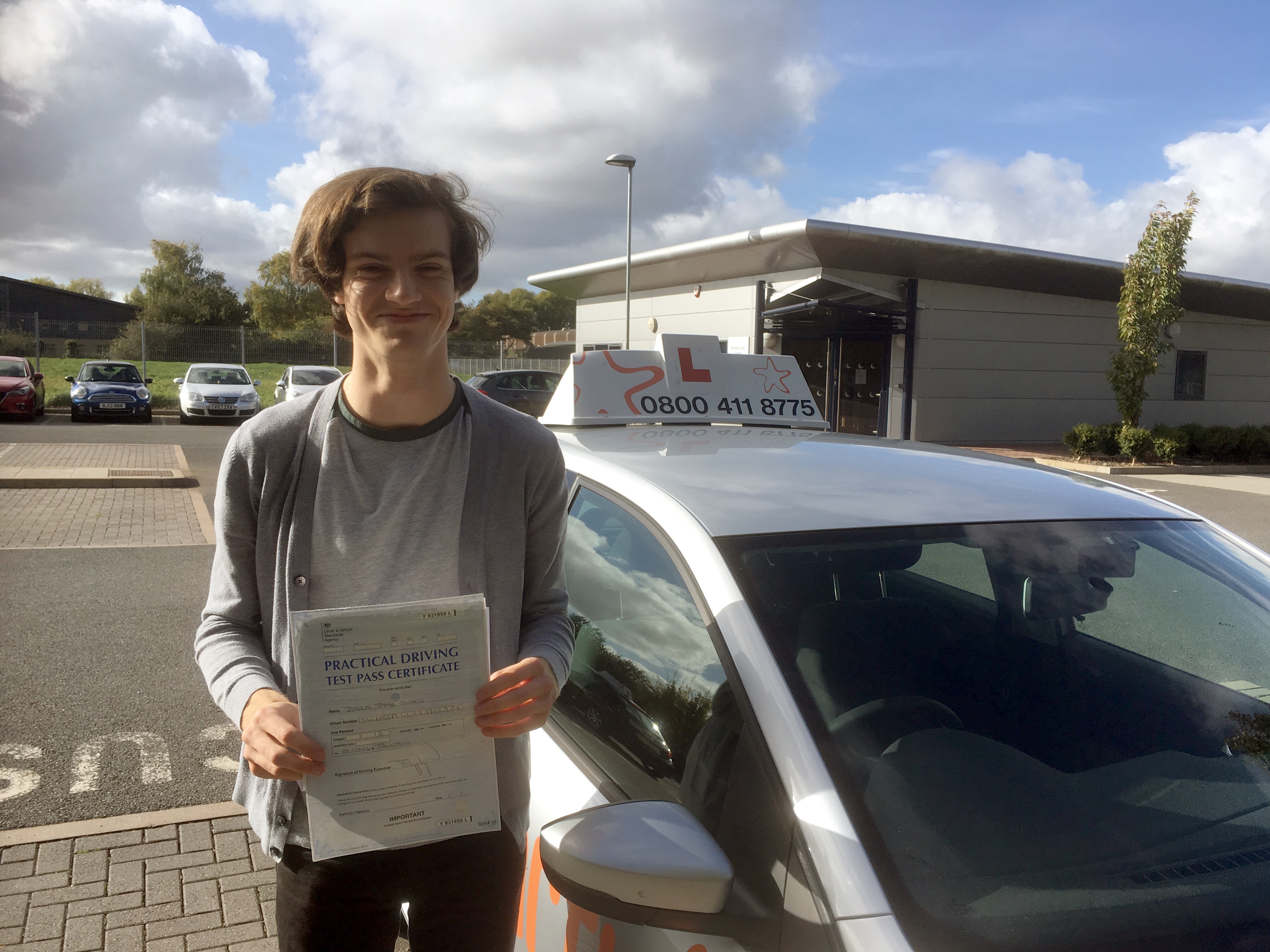 Josh with his Practical Driving Test Pass Certificate outside Taunton Driving Test Centre