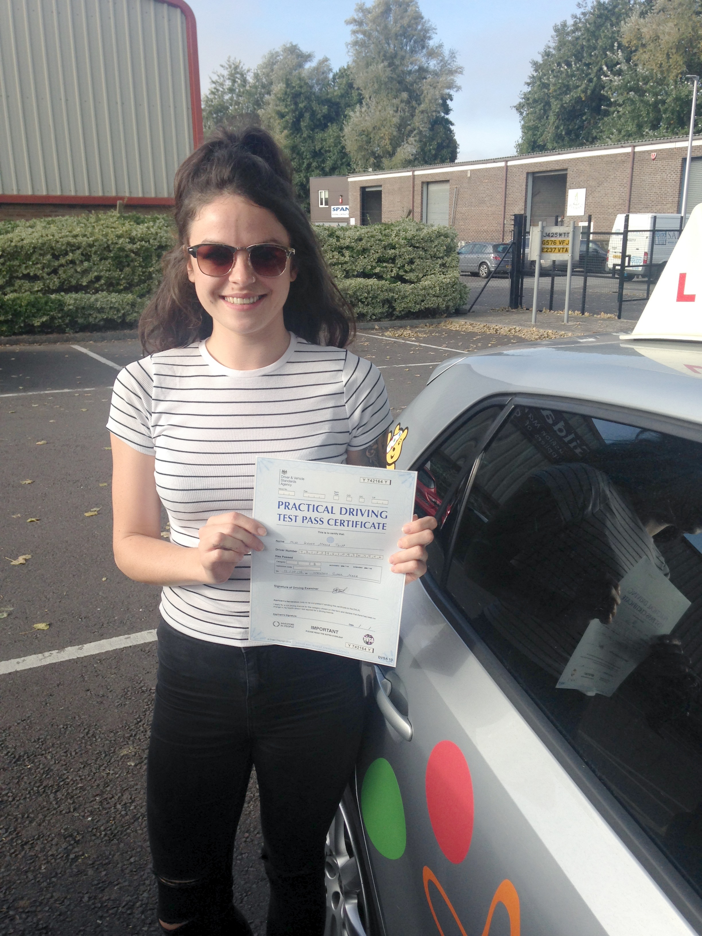 Kelly with her Practical Driving Test Pass Certificate outside Weston-super-mare Driving Test Centre.