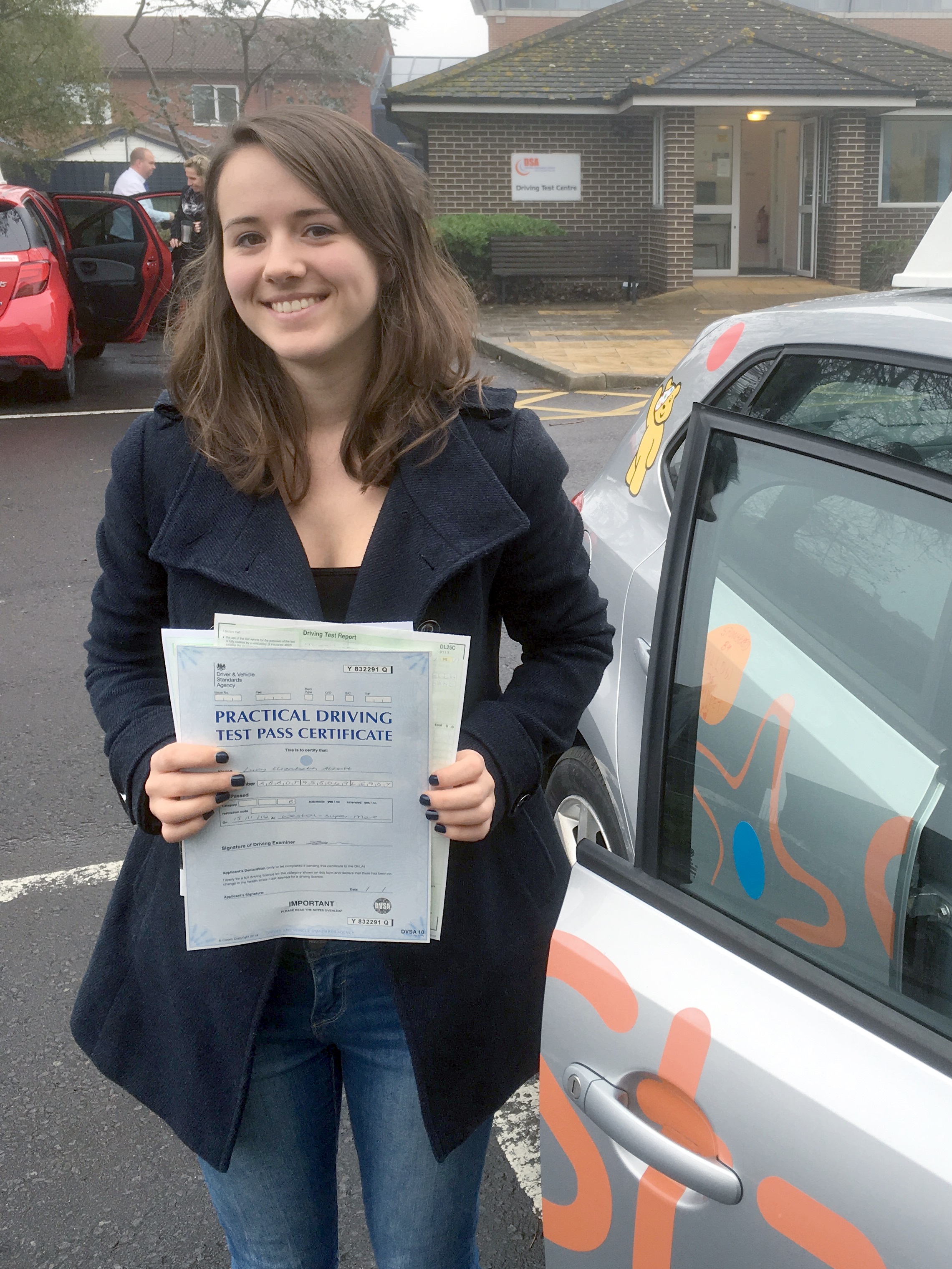 Lucy with her Practical Driving Test Pass Certificate outside Weston-super-mare Driving Test Centre