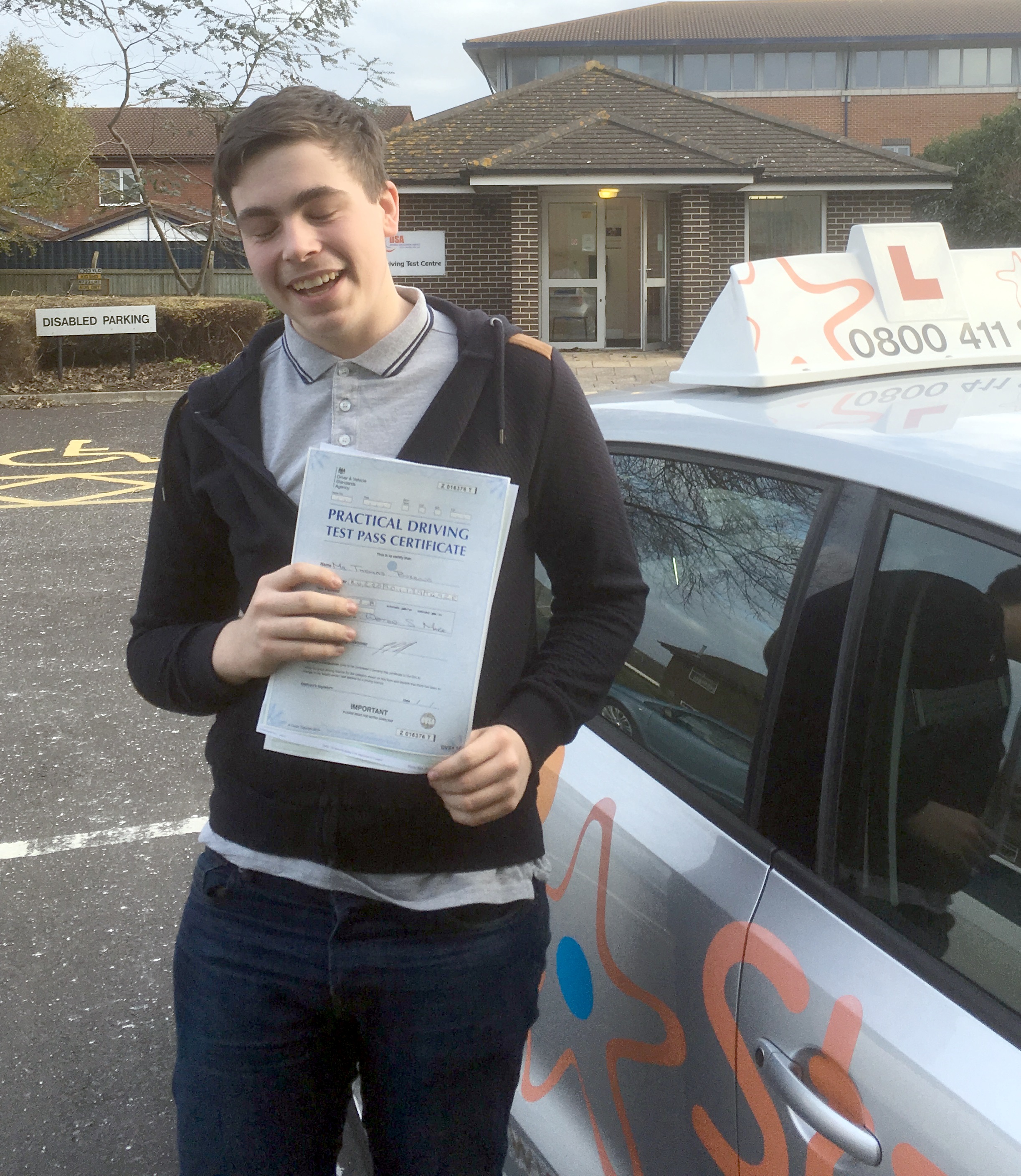 Tommy with his Practical Driving Test Pass Certificate outside Weston-super-Mare Driving Test Centre