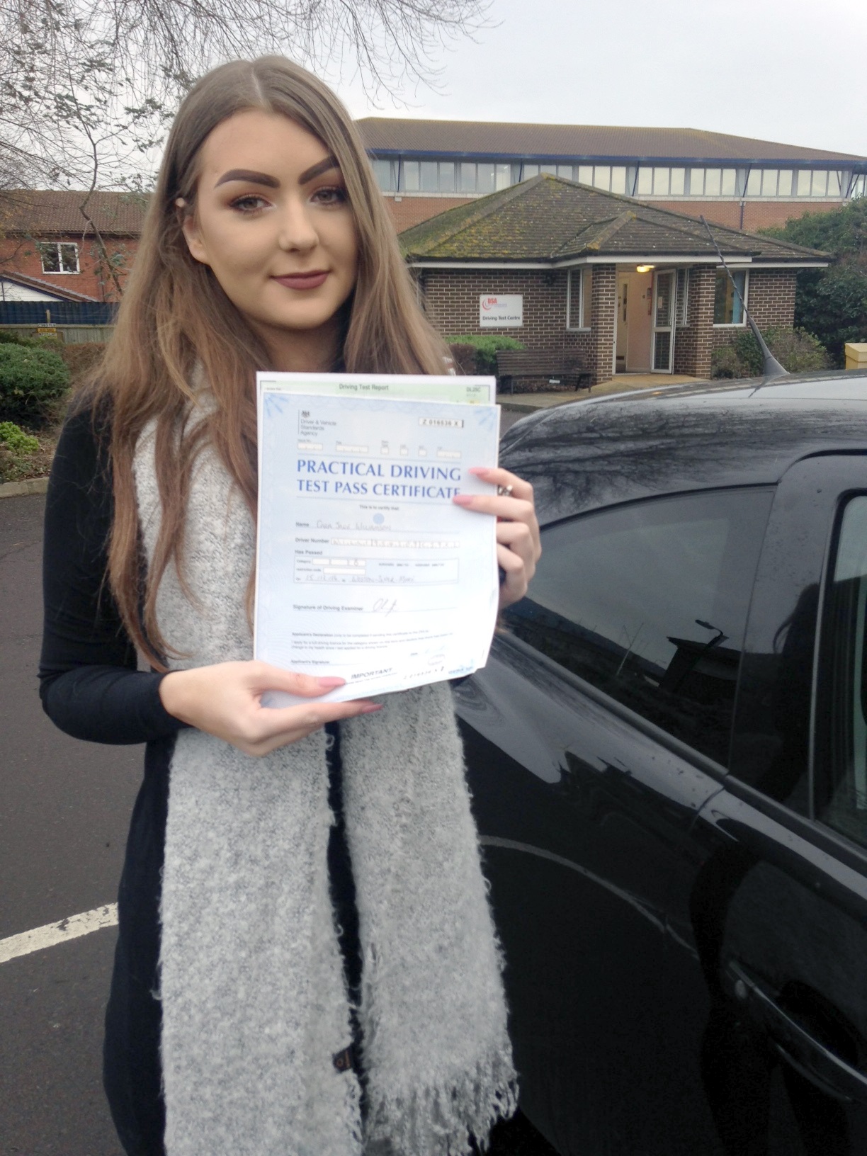 Cara with her Pracitcal Driving Test Pass Certificate outside Weston-super-mare Driving Test Centre