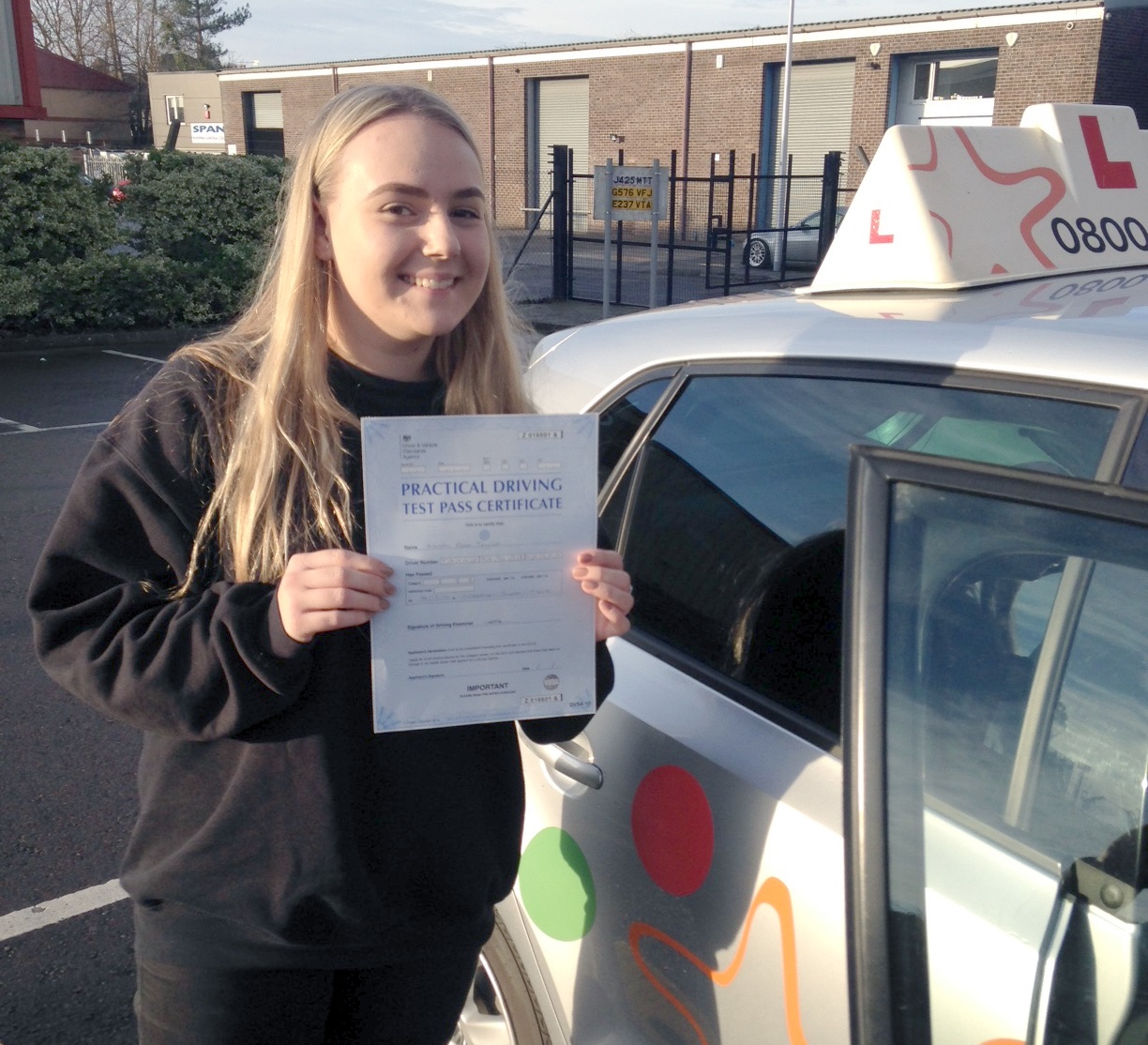 Naomi with her Practical Driving Test Pass Certificate outside Weston-super-mare Driving Test Centre
