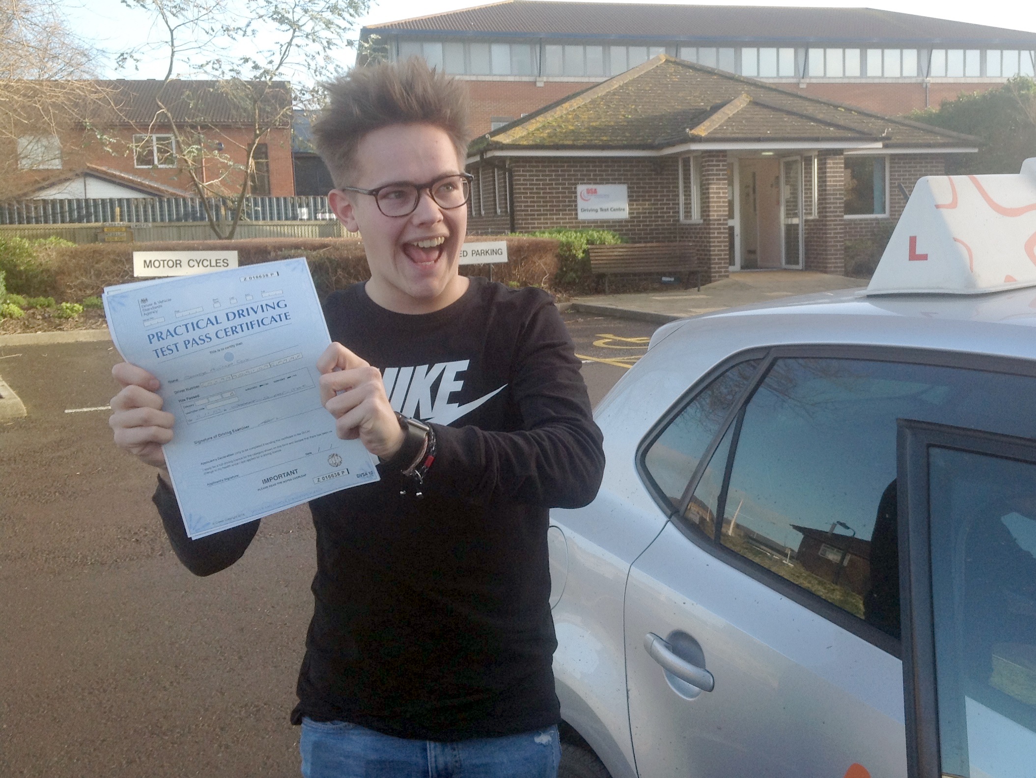 George with his Practical Driving Test Pass Certificate outside Weston-super-mare Driving Test Centre.