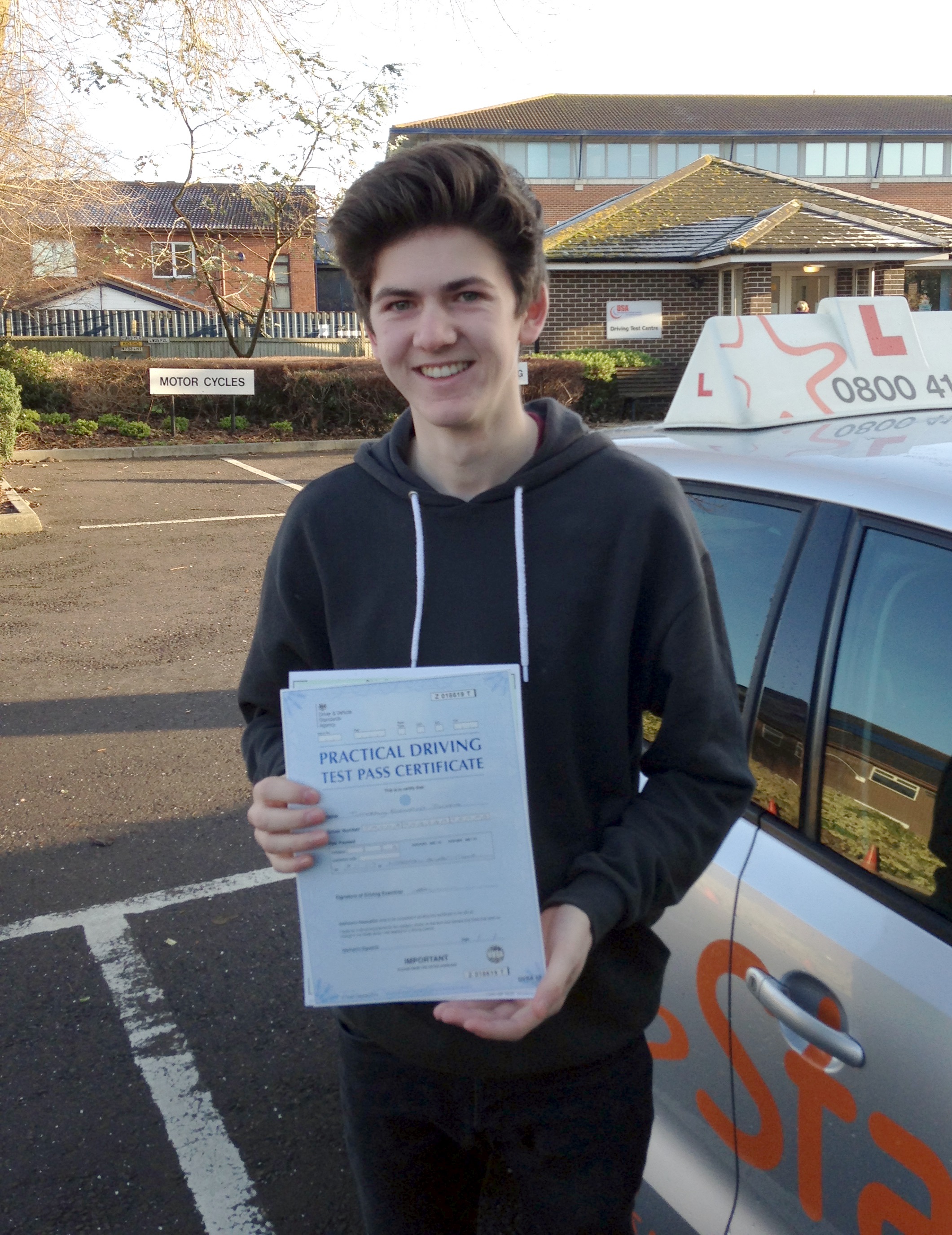 Tim with his Practical Driving Test Pass Certificate outside Weston-super-mare Driving Test Centre.