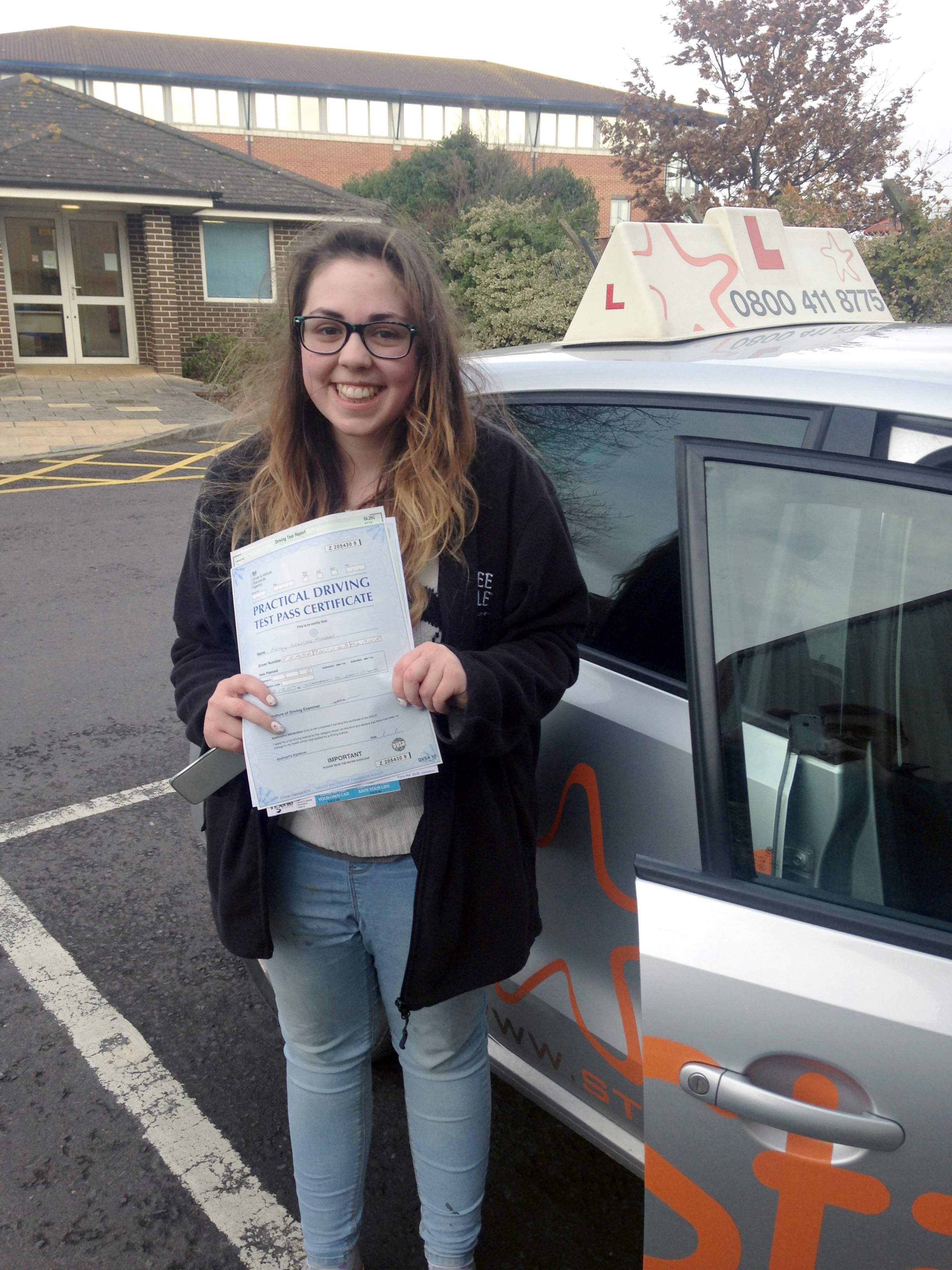 Amy with her Practical Driving Test Pass Certificate outside Weston-super-mare Driving Test Centre